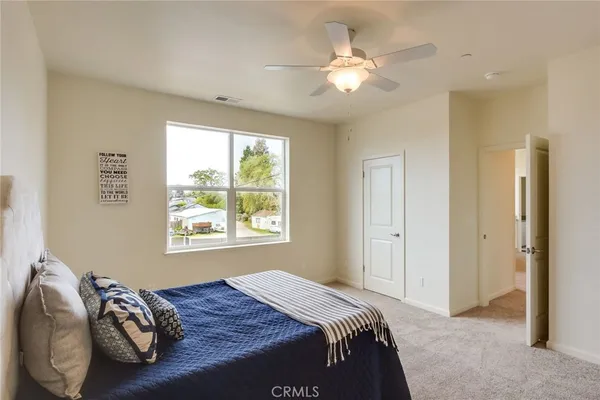 a bedroom with a bed and a chandelier