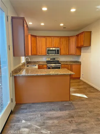 a kitchen with wooden cabinets and a sink