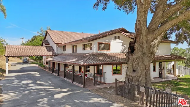 a view of a large trees in front of a house