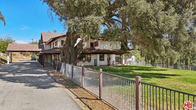 a view of a park with large trees