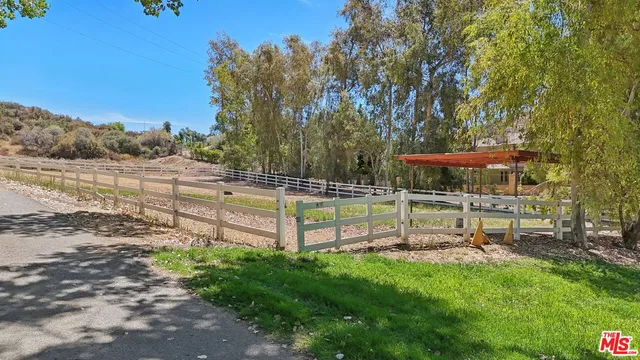a view of a chairs and tables in the back yard of the house