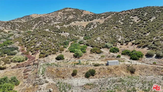 a bathroom with a granite countertop sink and a large mirror