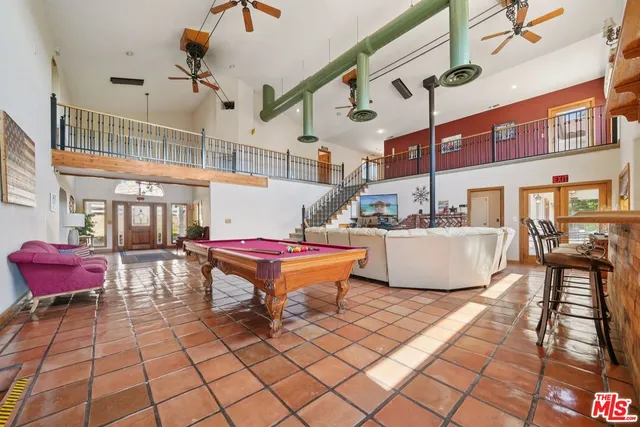 a view of a livingroom with furniture window and a ceiling fan