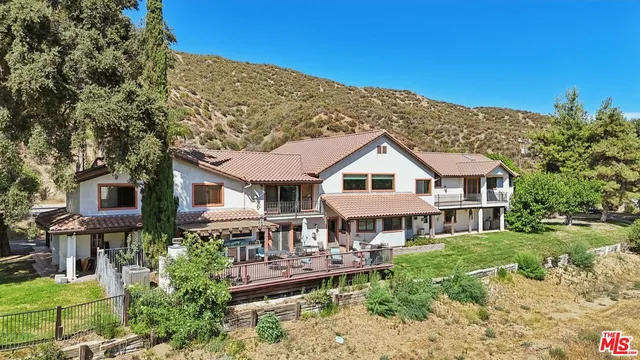a front view of a house with a yard table and chairs