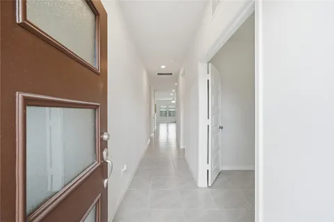 a living room with furniture flat screen tv and a window