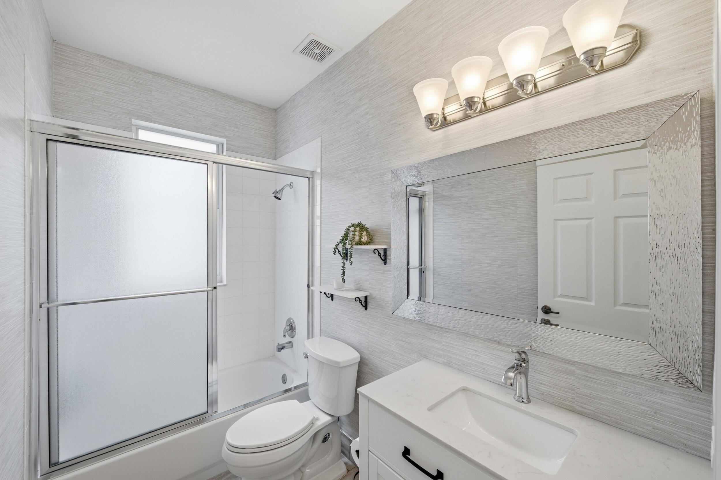 8534 Vía D Oro Boca Raton, FL 33433 - Photo 30 of 34 a white toilet sitting next to a bathroom sink