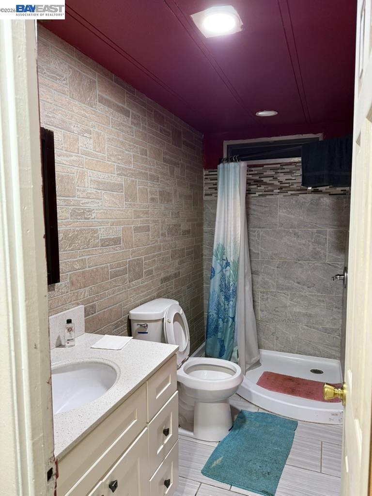 4404 Raiders Way, Unit 81 Modesto, CA 95355 - Photo 11 of 17 a bathroom with a sink a toilet and shower