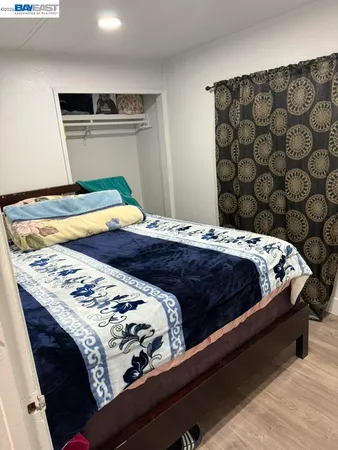 a bedroom with a bed and curtain