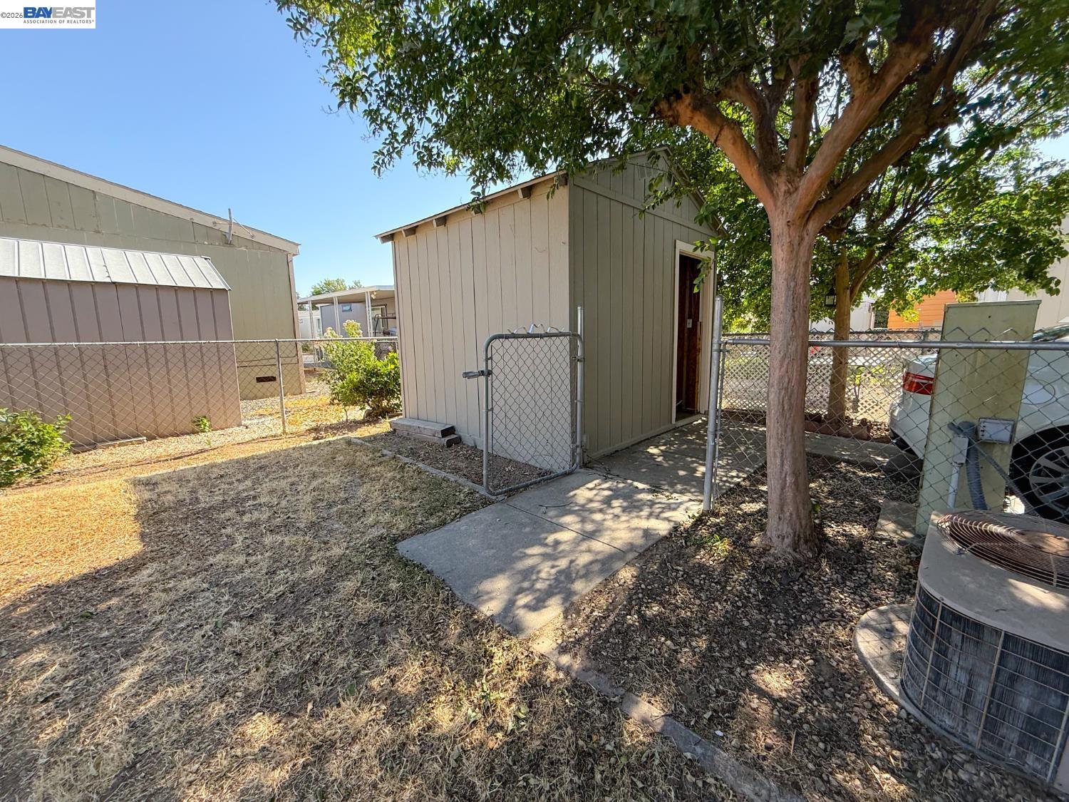 4404 Raiders Way, Unit 81 Modesto, CA 95355 - Photo 16 of 17 a backyard of a house with lots of green space
