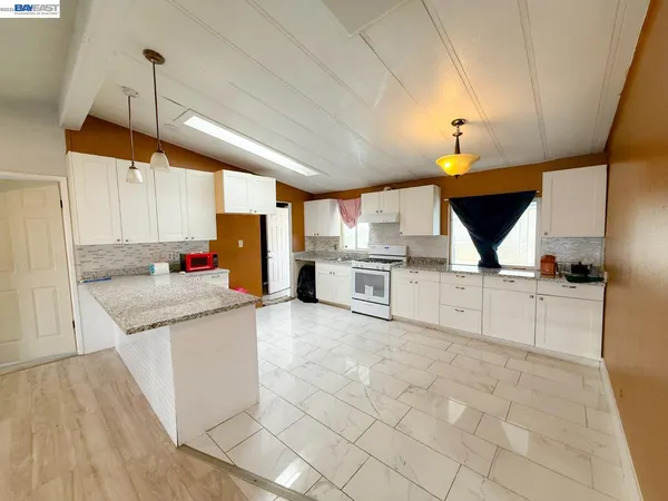 a kitchen with stainless steel appliances granite countertop a sink and cabinets