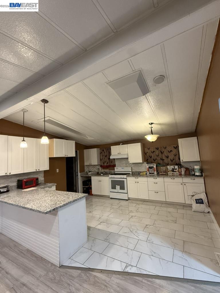 4404 Raiders Way, Unit 81 Modesto, CA 95355 - Photo 3 of 17 a large white kitchen with a large window and stainless steel appliances
