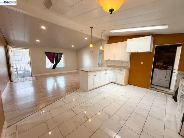 a view of a kitchen with a sink and a microwave