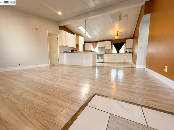 a view of kitchen with cabinets and wooden floor
