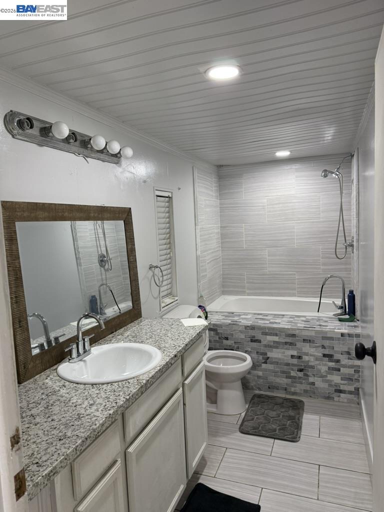 4404 Raiders Way, Unit 81 Modesto, CA 95355 - Photo 6 of 17 a bathroom with a granite countertop sink a toilet and a mirror