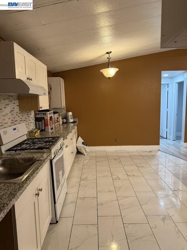 4404 Raiders Way, Unit 81 Modesto, CA 95355 - Photo 8 of 17 a kitchen with a stove cabinets and a sink
