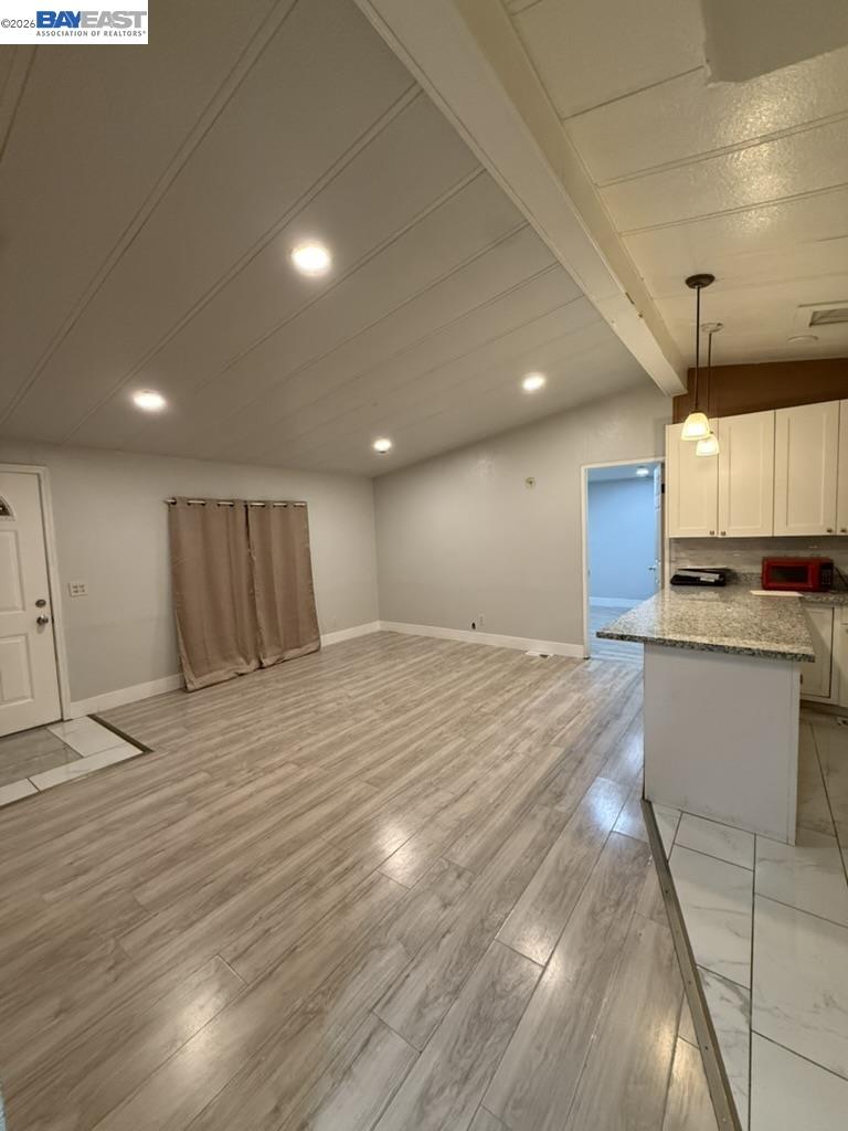 4404 Raiders Way, Unit 81 Modesto, CA 95355 - Photo 9 of 17 a big room with wooden floor kitchen view and a window