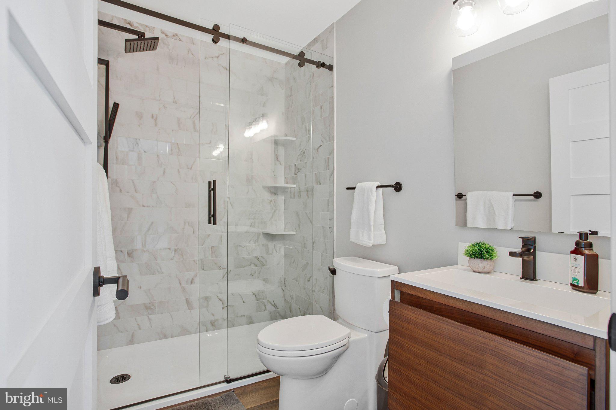6146 Drum Point Road Deale, MD 20751 - Photo 45 of 75 a bathroom with a sink a toilet and shower