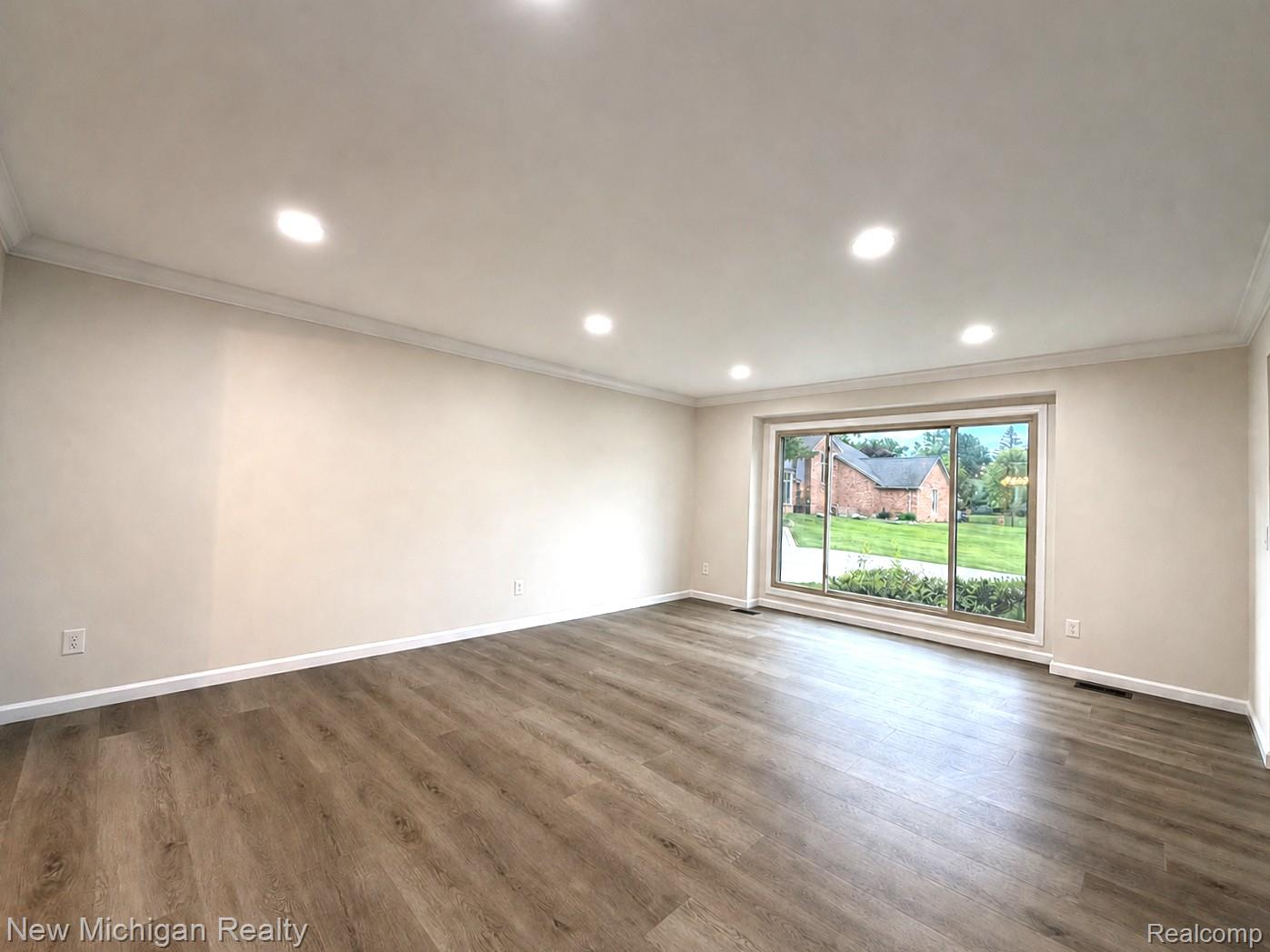 650 Deerfield Court Rochester, MI 48309 - Photo 10 of 37 Spacious & Bright Living room featuring Luxurious waterproof wood-finish flooring, recessed lighting, and crown molding