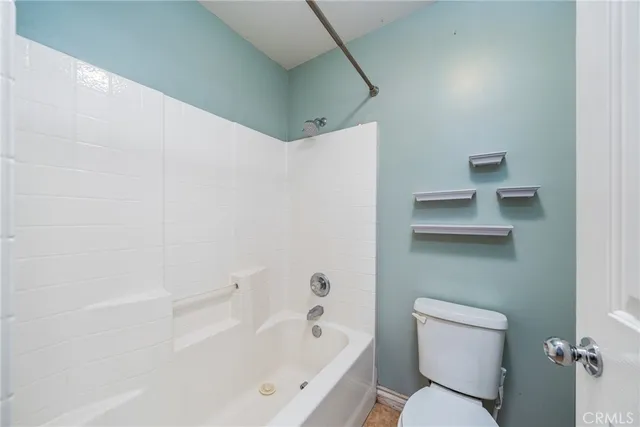 a bathroom with a toilet and a bathtub