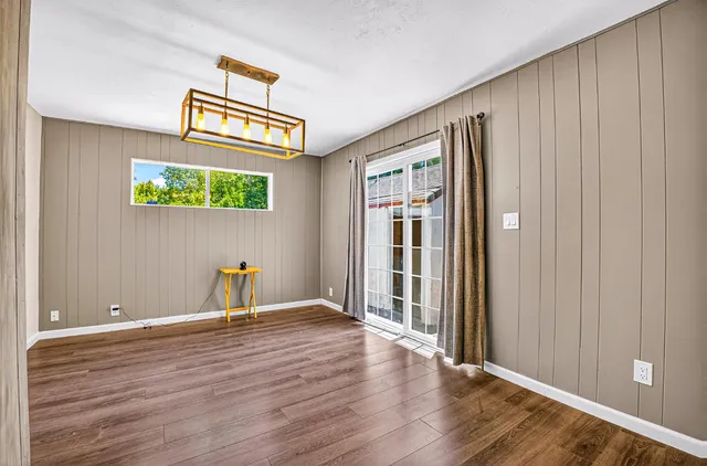 an entryway at a room with wooden floor