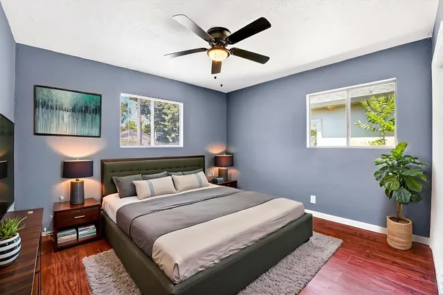 a view of room with hardwood floor and ceiling fan