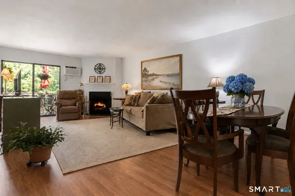 a living room with furniture fireplace and a large window