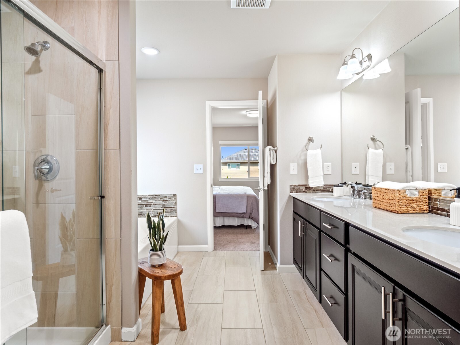 3923 186th Place Southeast Bothell, WA 98012 - Photo 24 of 40 a en suite bathroom with a double vanity sink a large mirror and shower