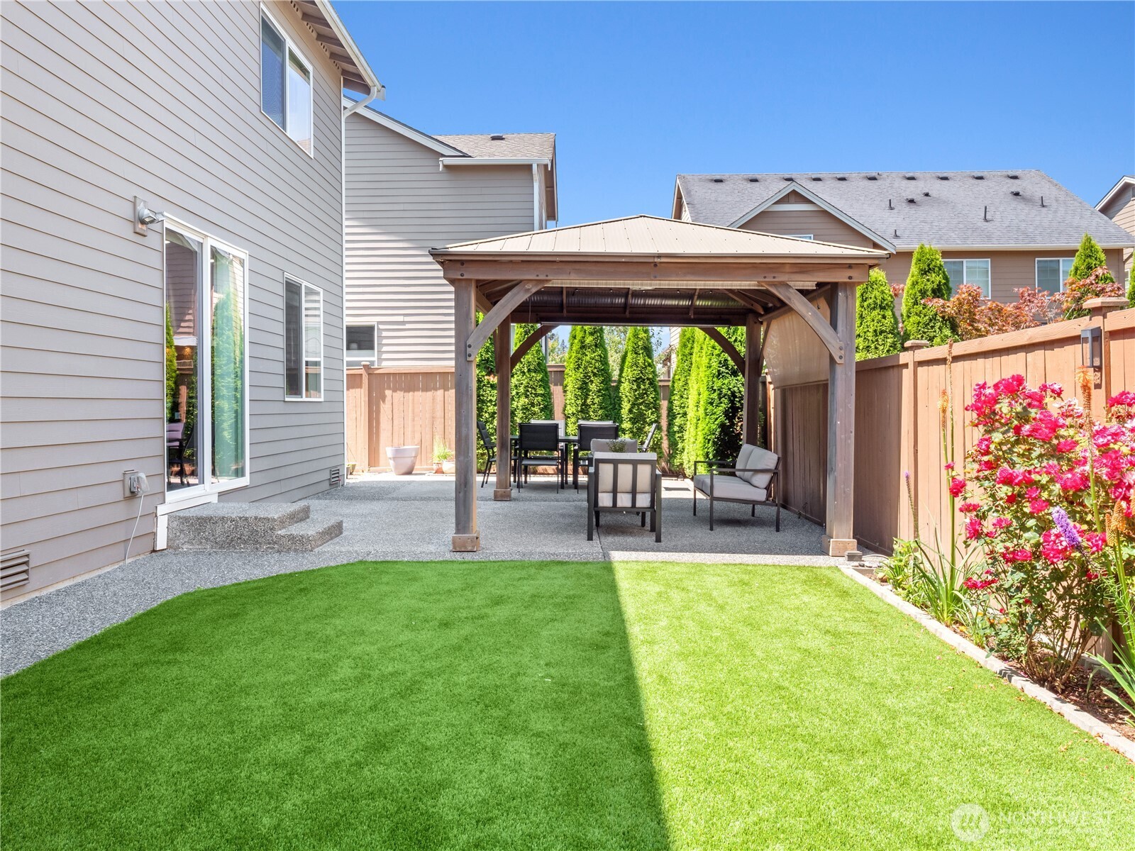 3923 186th Place Southeast Bothell, WA 98012 - Photo 34 of 40 a view of a patio with table and chairs under an umbrella