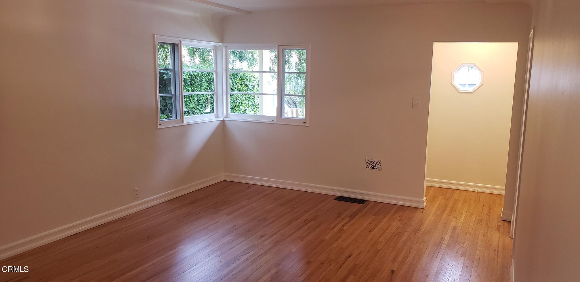 1130 Heather Square Pasadena, CA 91104 - Photo 2 of 12 an empty room with wooden floor and windows