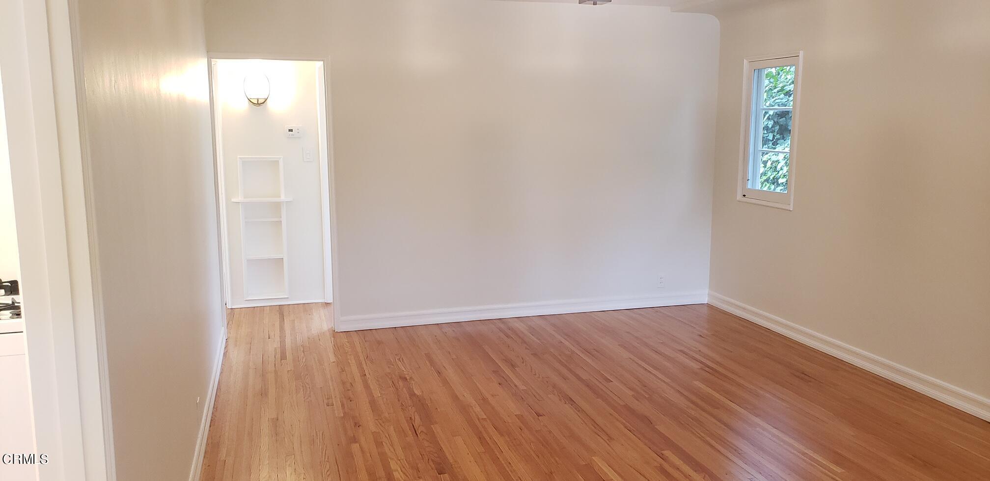 1130 Heather Square Pasadena, CA 91104 - Photo 3 of 12 a view of an empty room with wooden floor and a bathroom