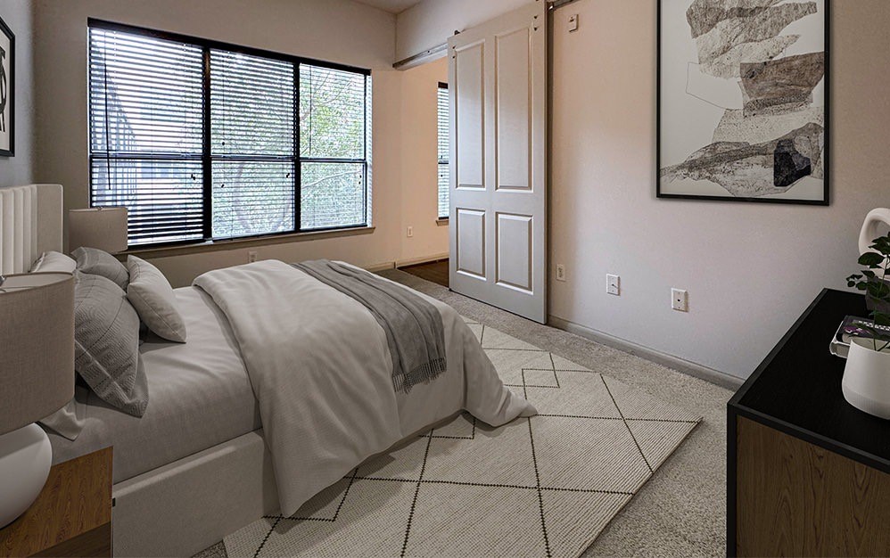 306 McGowen Street, Unit 1121 Houston, TX 77006 - Photo 3 of 20 Retreat to a spacious primary bedroom featuring large windows that fill the space with natural light, plush carpeting and a generous walk-in closet for added comfort and convenience.