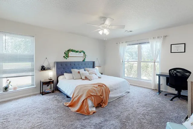 a bedroom with a bed and a chandelier
