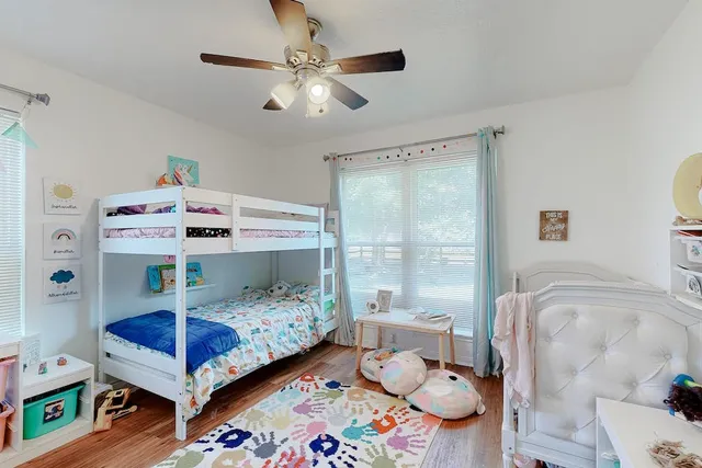 a bedroom with a bed and a chandelier