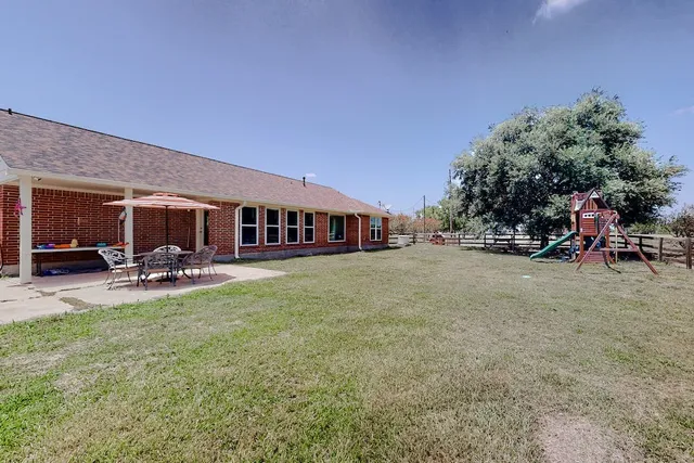 a view of a house with sitting area and swimming pool