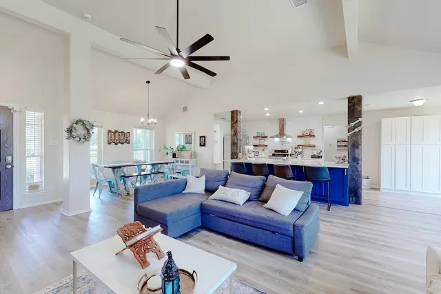 a living room with furniture and kitchen view