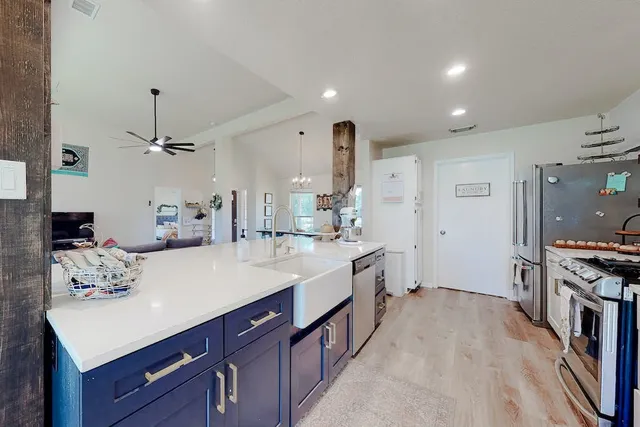 a large kitchen with kitchen island a sink stove and refrigerator