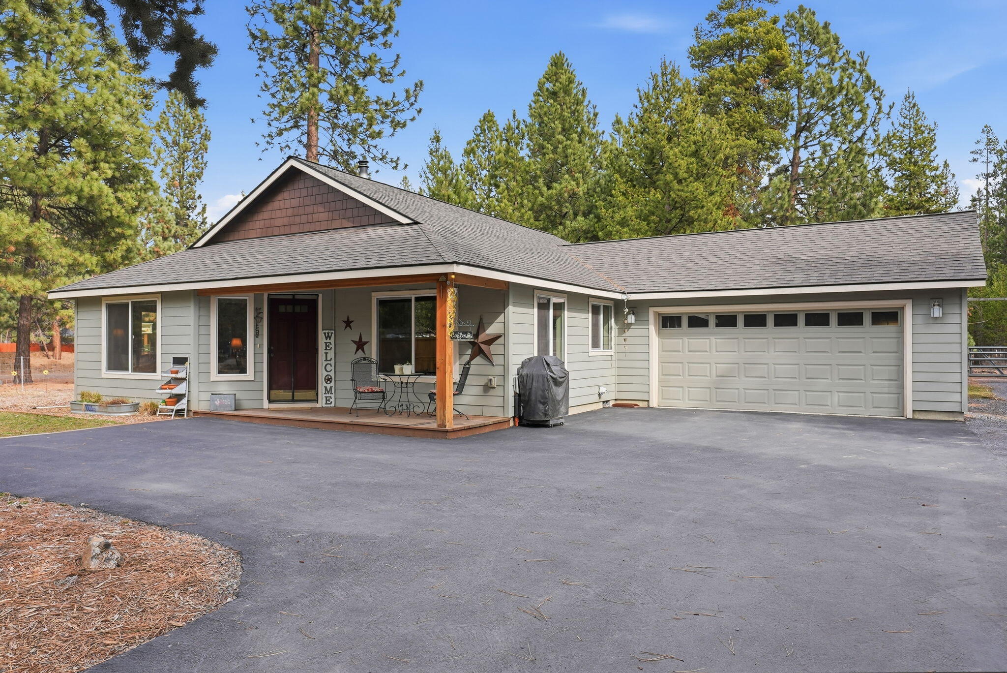 a view of a house with a yard and large tree