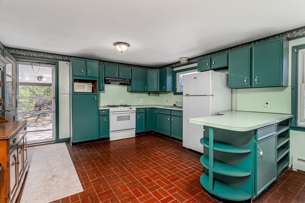 73 Spur Road Dover, NH 03820 - Photo 13 of 26 a kitchen with a cabinets a sink and a refrigerator