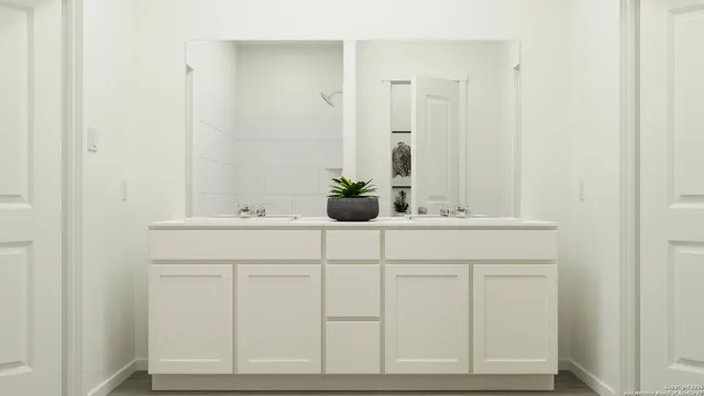 a bedroom with a bed and mirror