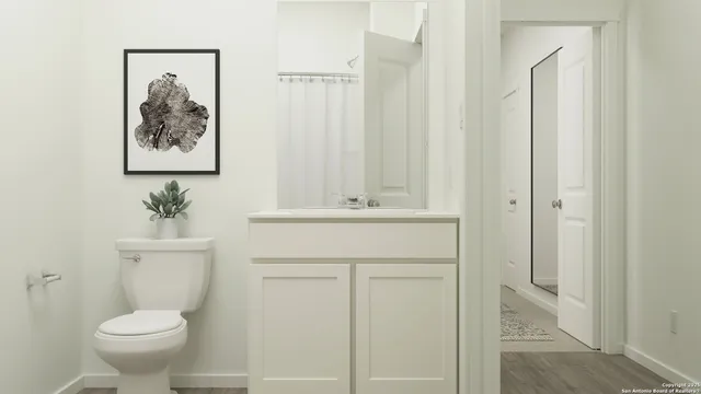 a bathroom with a toilet sink and a mirror