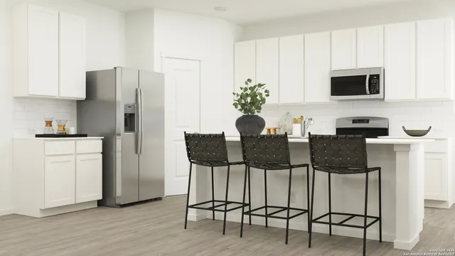 a kitchen with stainless steel appliances kitchen island granite countertop a table and chairs