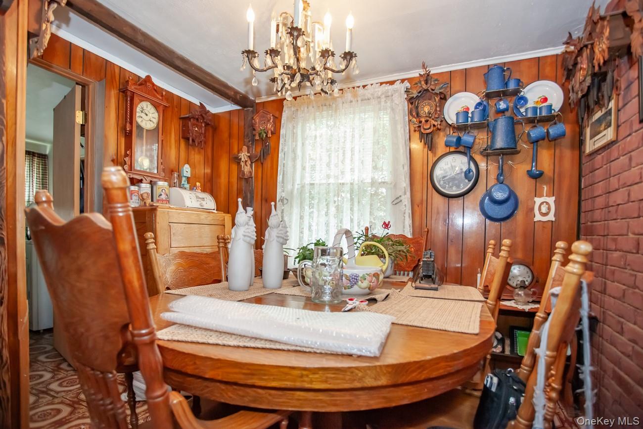 211 Broadway Verplanck, NY 10596 - Photo 16 of 48 a dining room with chandelier and wooden floor