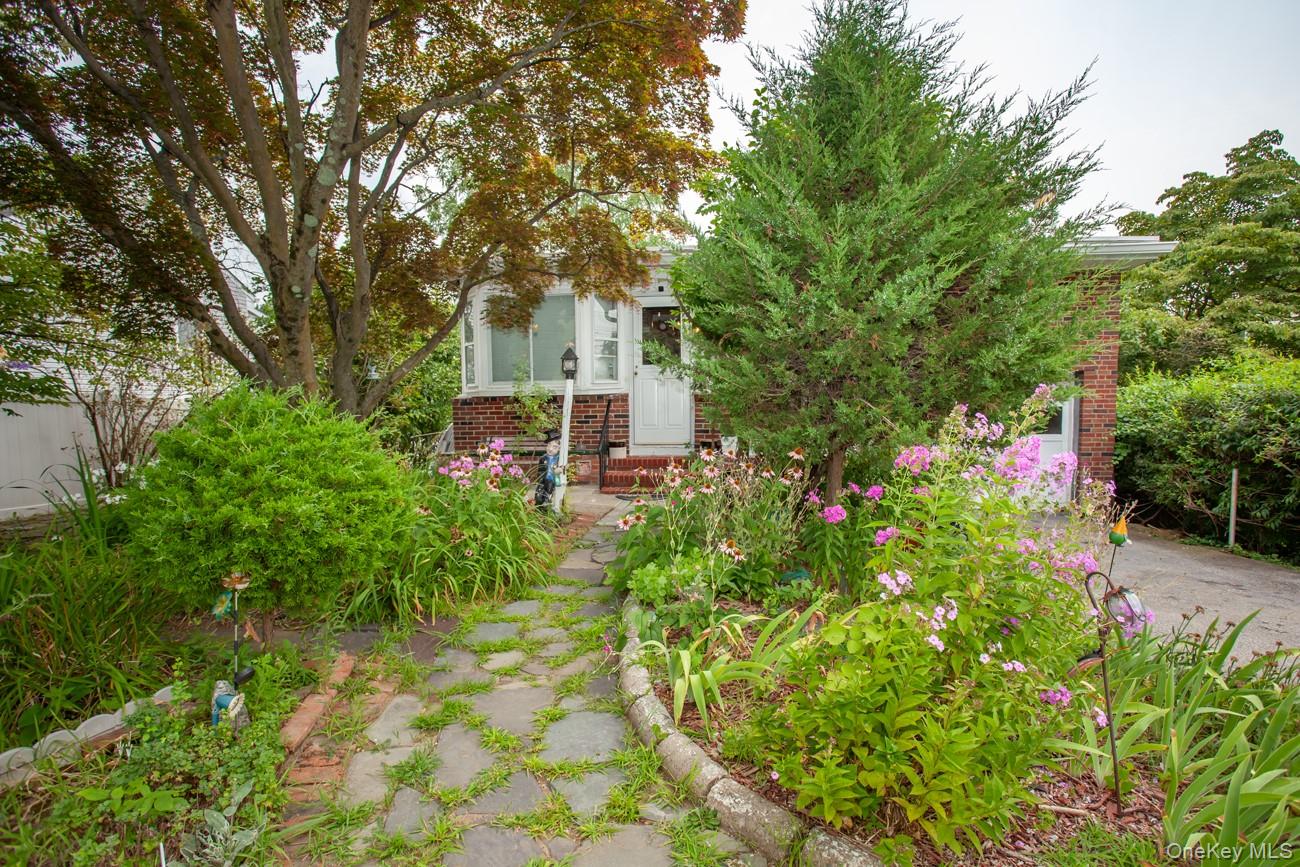 211 Broadway Verplanck, NY 10596 - Photo 2 of 48 a front view of a house with a yard and fountain in middle