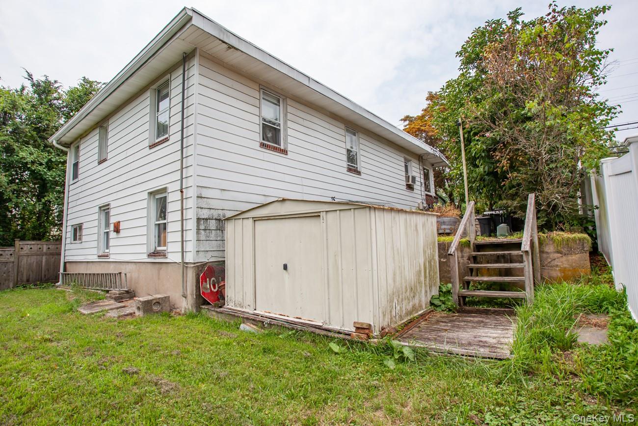 211 Broadway Verplanck, NY 10596 - Photo 44 of 48 a view of backyard with small cabin and wooden fence