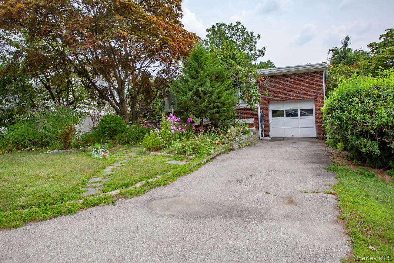 211 Broadway Verplanck, NY 10596 - Photo 47 of 48 a front view of a house with a garden and yard