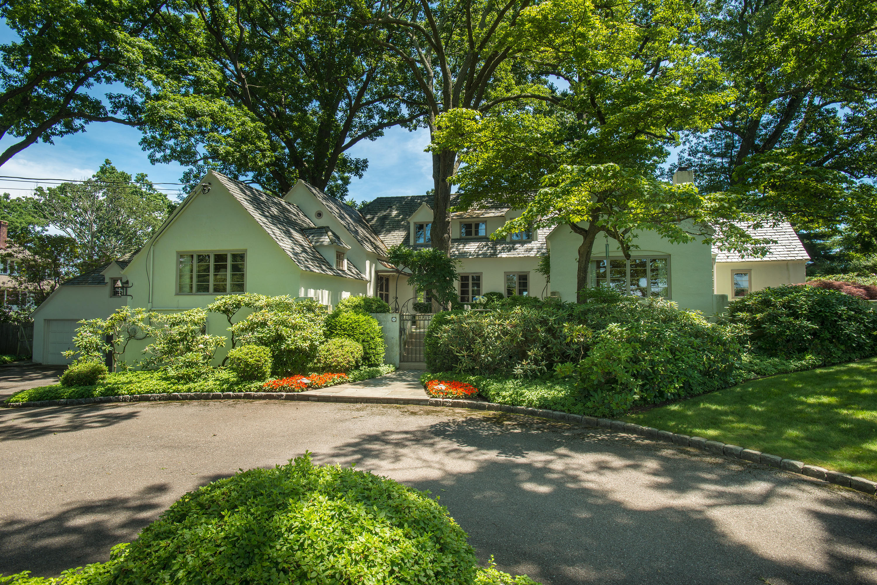11 Contentment Island Road Darien, CT 06820 - Photo 1 of 31 a front view of a house with a yard and potted plants