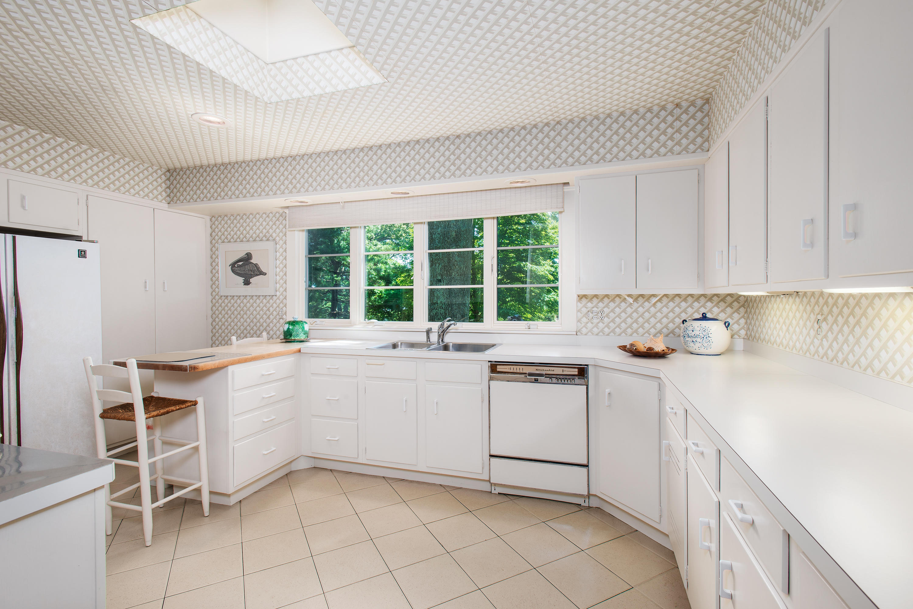 11 Contentment Island Road Darien, CT 06820 - Photo 14 of 31 a kitchen with white cabinets and white appliances