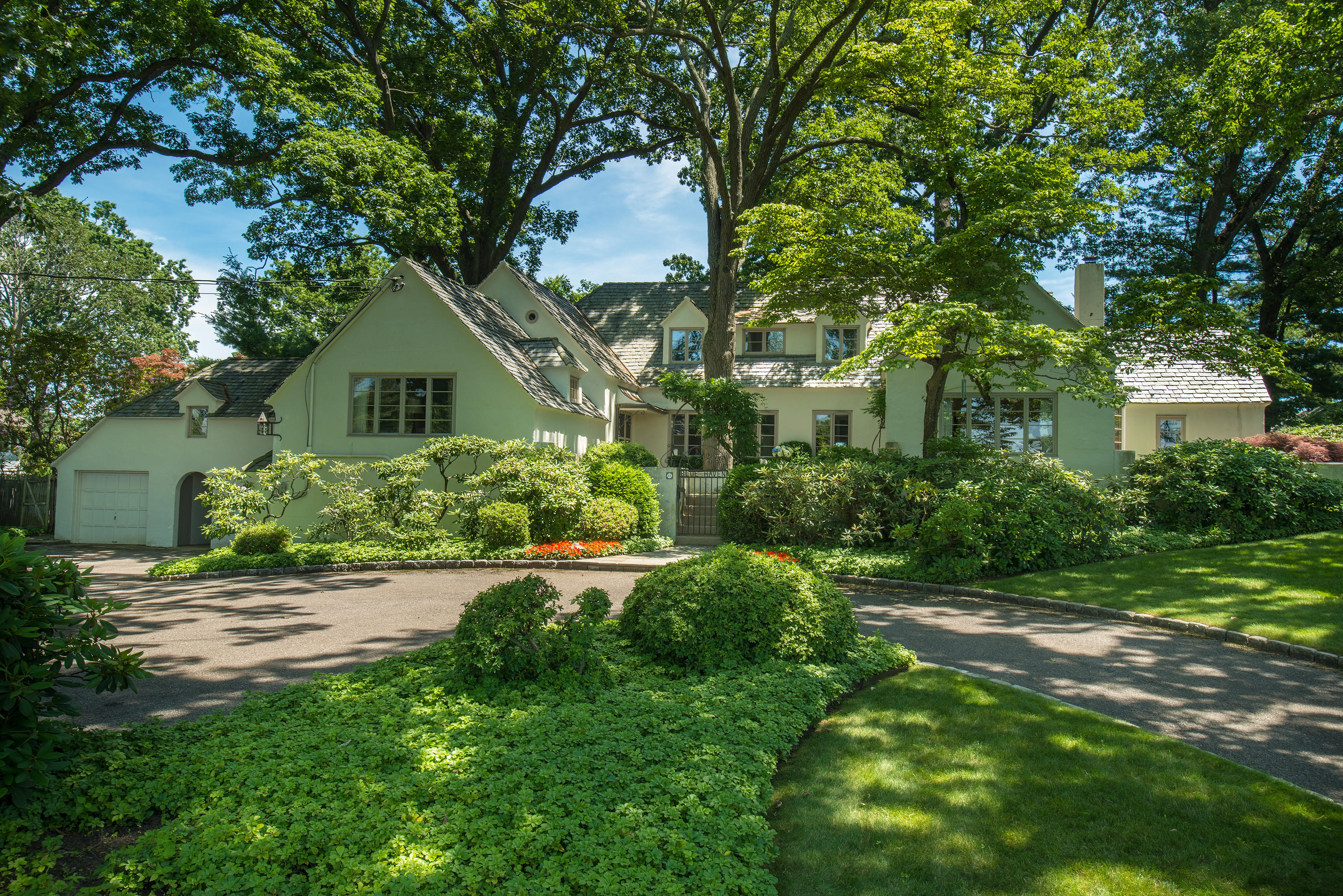11 Contentment Island Road Darien, CT 06820 - Photo 2 of 31 a front view of a house with a yard and trees