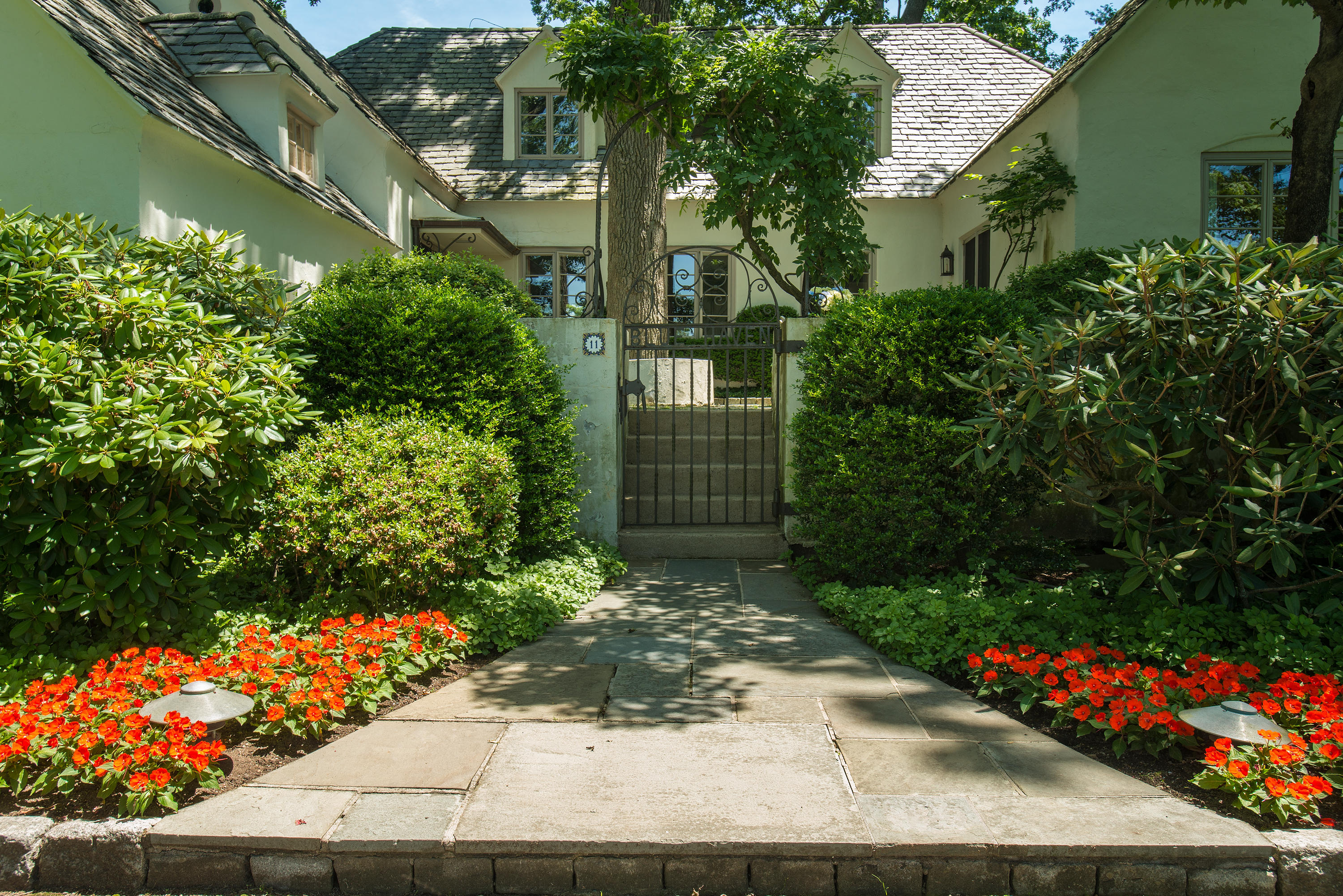 11 Contentment Island Road Darien, CT 06820 - Photo 6 of 31 a front view of a house with a yard and flowers