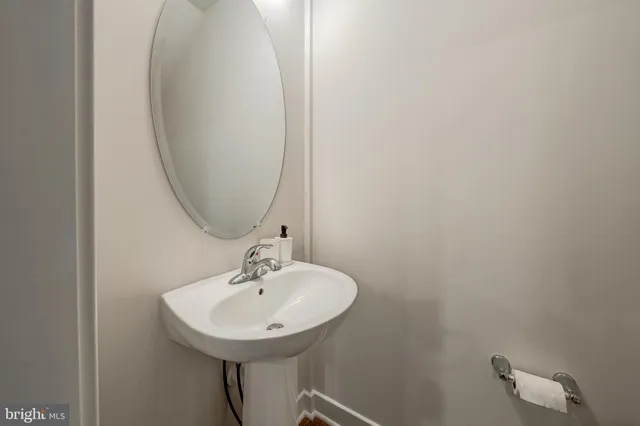 a bathroom with a sink a mirror and a toilet